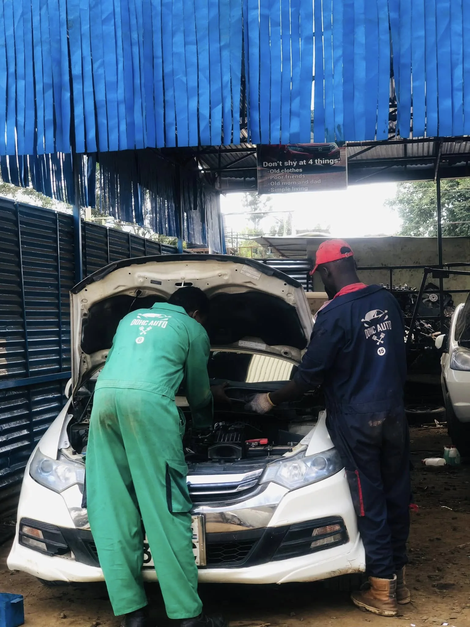 DOHC Auto mechanics in Nairobi repairing a Honda engine.