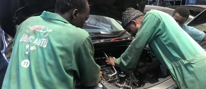 Mechanic in Nairobi Kenya repairing a Honda engine